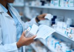 Pharmacist holding prescriptions