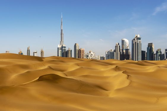 Looking along desert towards a business district