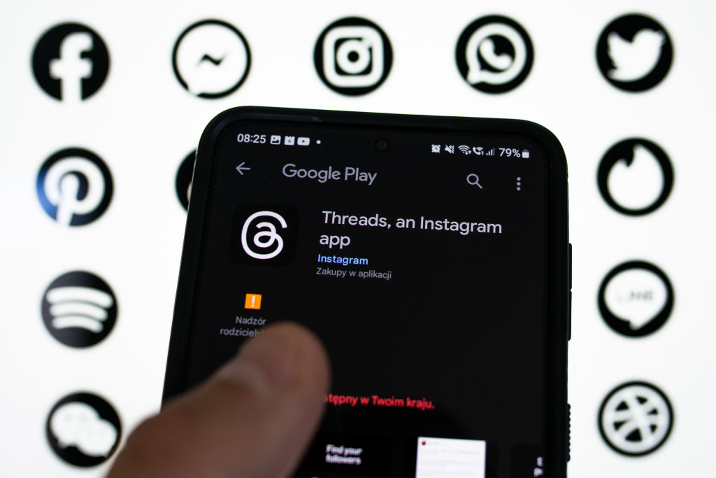 Image of Threads, an Instagram app in the app store with twitter, whatsapp, instagram and facebook logos in the background