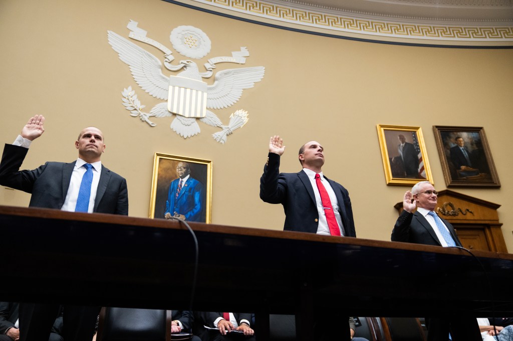 UNITED STATES - JULY 26: From left, Ryan Graves, executive director of Americans for Safe Aerospace, David Grusch, former National Reconnaissance Office representative on the Defense Department's Unidentified Aerial Phenomena Task Force, and retired Navy Commander David Fravor, are sworn in during the House Oversight and Accountability Subcommittee on National Security, the Border, and Foreign Affairs hearing titled "Unidentified Anomalous Phenomena: Implications on National Security, Public Safety, and Government Transparency," in Rayburn Building on Wednesday, July 26, 2023. (Tom Williams/CQ-Roll Call, Inc via Getty Images)