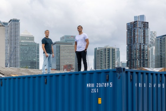 Raft founders standing on a shipping container
