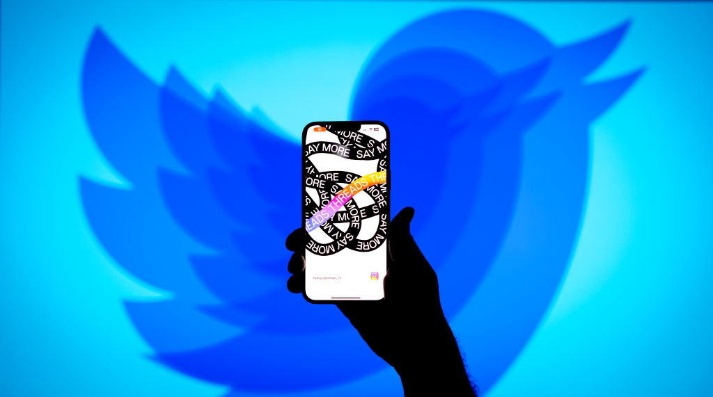 The Instagram Threads app is seen on a phone with a Twitter logo in the background in this illustration photo on 06 July, 2023 in Warsaw, Poland. (Photo by Jaap Arriens/NurPhoto via Getty Images)