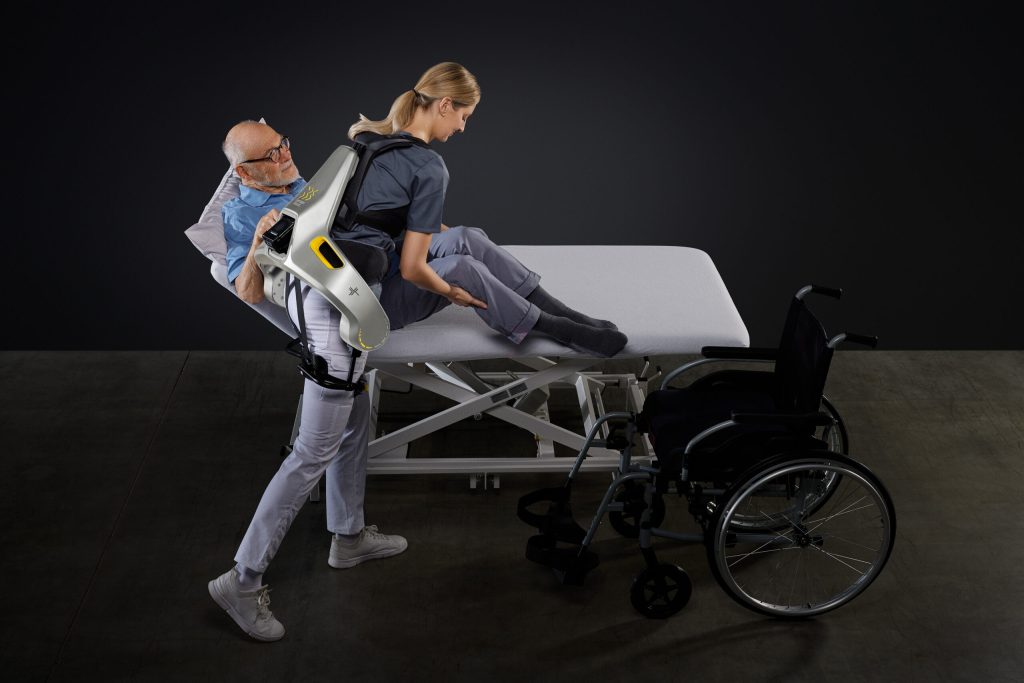 person wearing German Bionic exosuit lifting a patient
