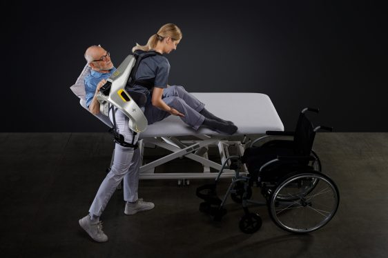 person wearing German Bionic exosuit lifting a patient