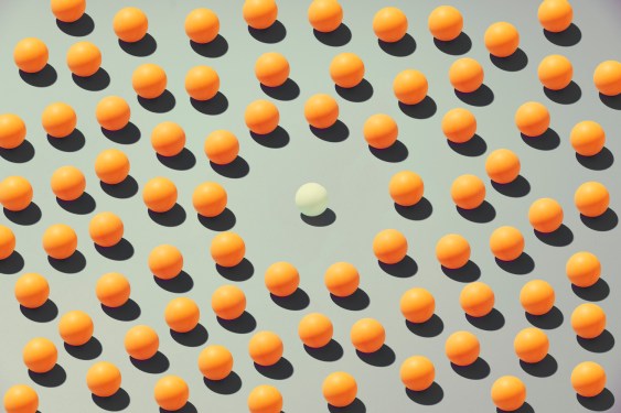 One of a kind: a white ball alone in a circle, surrounded by yellow balls, a symbol of social alienation