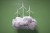 Digital generated image of multiple wind turbines on puffy cloud against green background.
