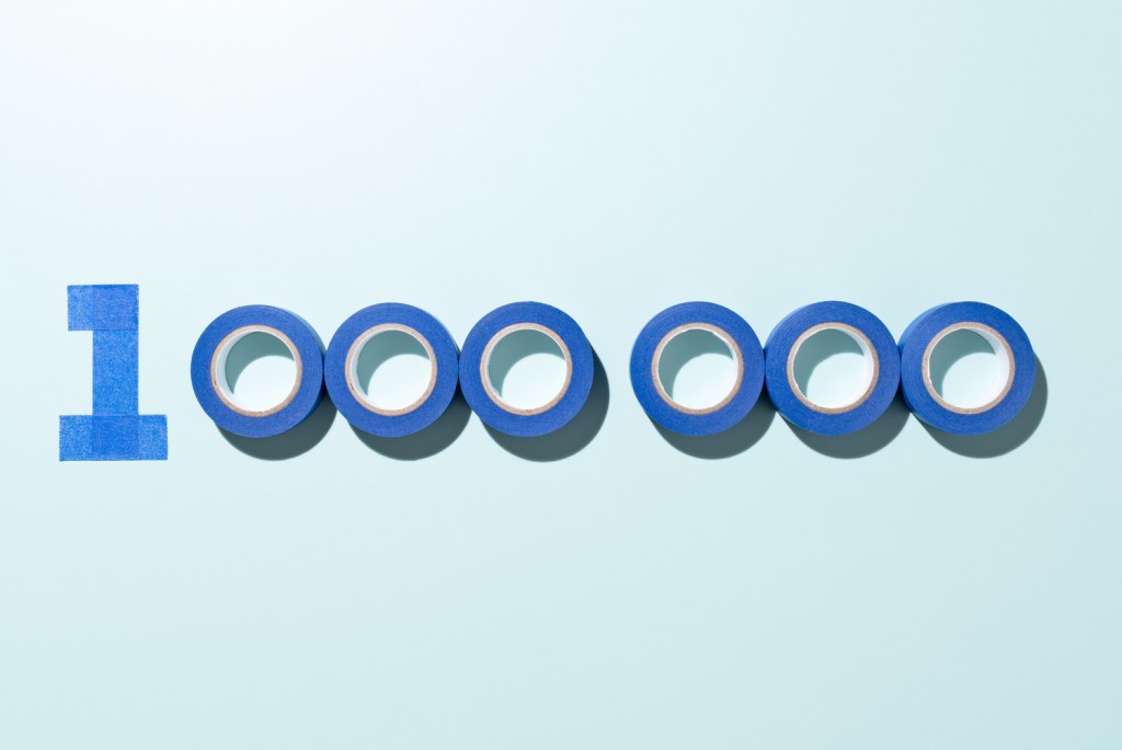One Million Number 1000000 Made of Blue Adhesive Tape on Blue Background Directly Above View.
