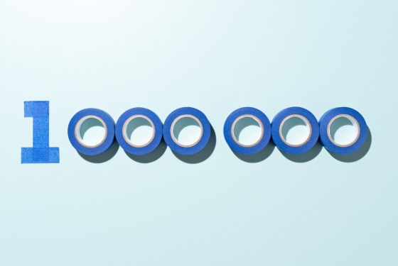 One Million Number 1000000 Made of Blue Adhesive Tape on Blue Background Directly Above View.