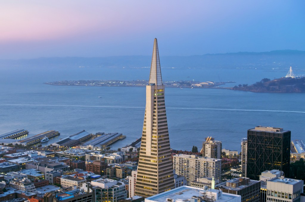 Aerial shot of the Downtown San Francisco and San Francisco Bay in the background in the evening. Shot in California, USA.