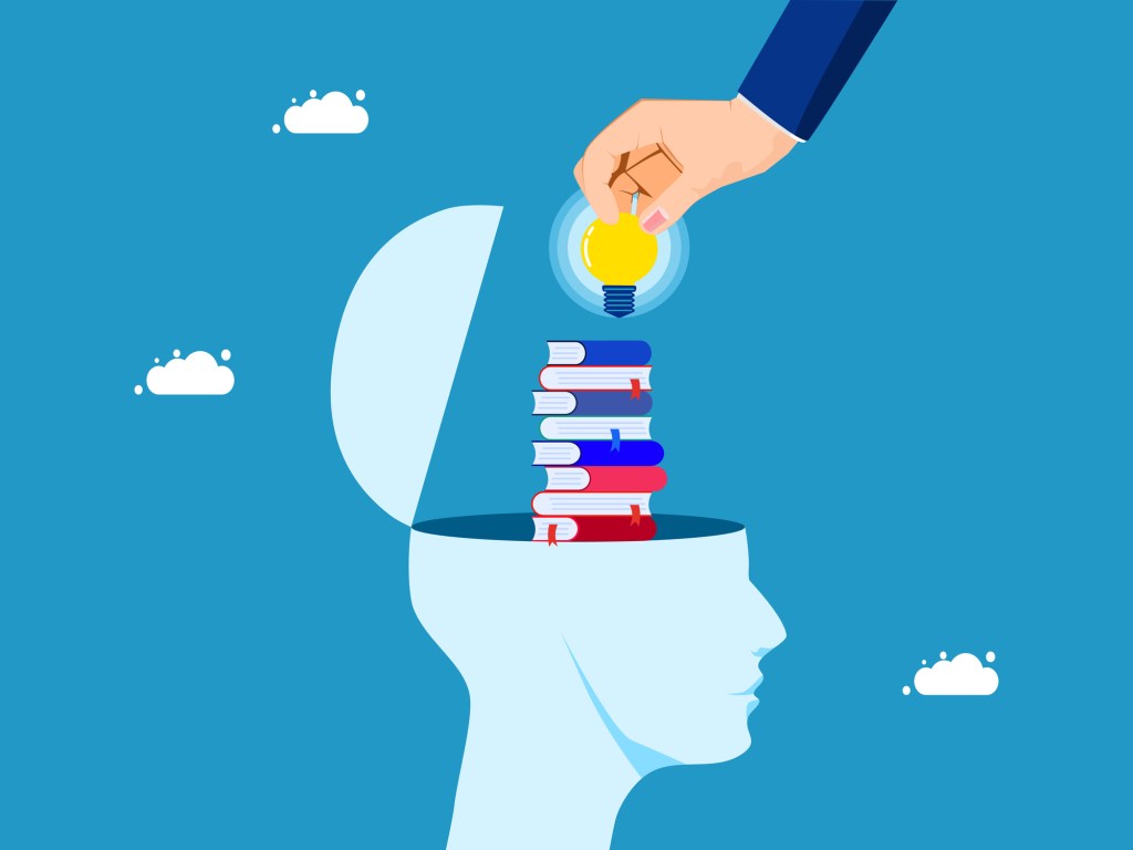 A head open with books coming out and a hand with a light bulb on top.
