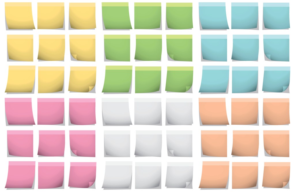A set of different colored post it notes on a wall.