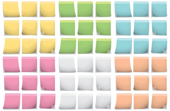 A set of different colored post it notes on a wall.