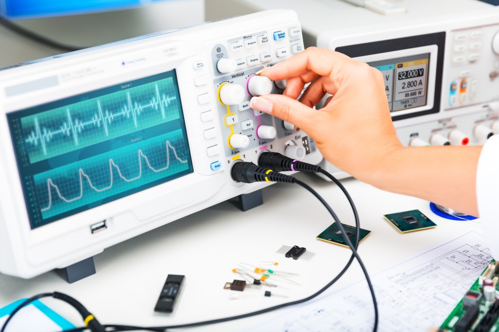 Digital oscilloscope is used by an experienced electronic engineer in the laboratory