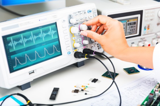 Digital oscilloscope is used by an experienced electronic engineer in the laboratory