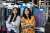 Refiberd founders Tushita Gupta and Sarika Bajaj stand before colorful textile samples.