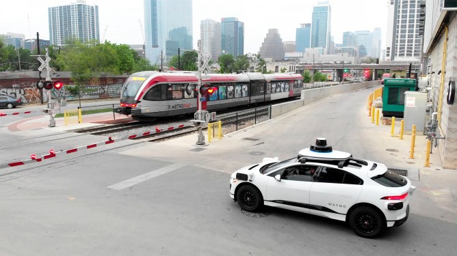 Waymo self-driving car stopped at a rail crossing in Austin