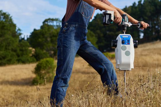 Scientist samples soil using a portable spectroscope from Yard Stick