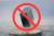 Red circle with slash over a levitating superconductor