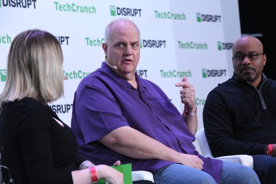 Allan Liska on stage at TechCrunch Disrupt with MK Palmore in the background on stage