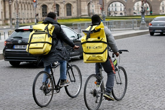 Food deliverers for Frichti ride their bicycles during the coronavirus (COVID-19) outbreak on February 17, 2021, in Paris, France.
