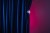 Midsection of woman holding curtain while standing against curtain