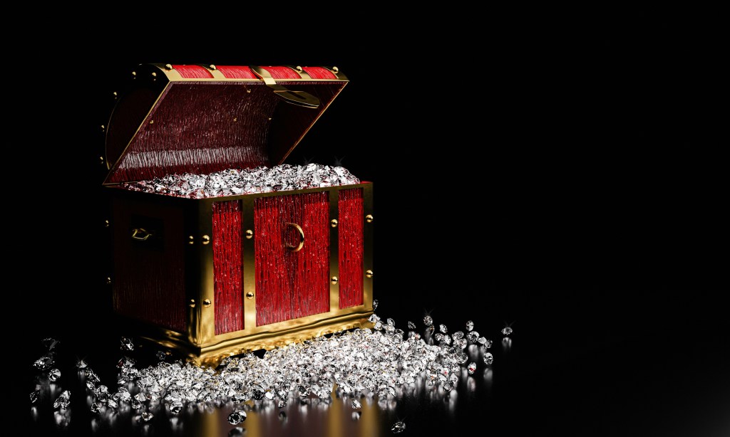 Diamonds in a vintage treasure chest, spilling onto the ground