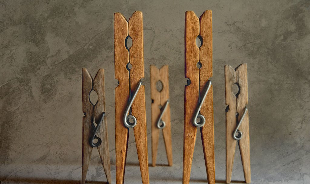 five clothespins standing in a group