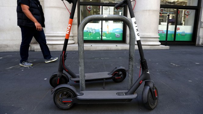 Spin and Bird scooters on a sidewalk