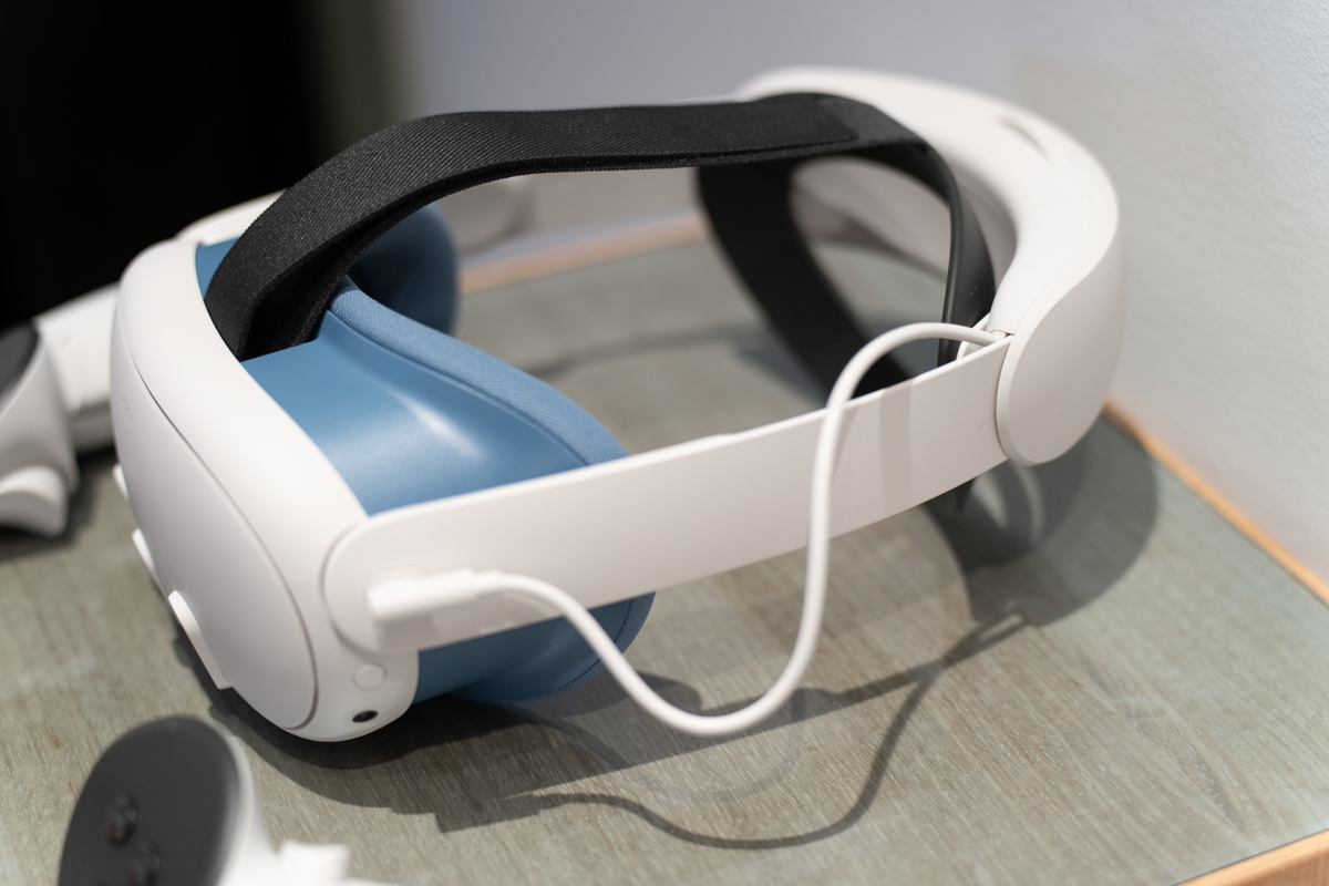 The Meta Quest 3 mixed reality headset, sitting on a surface with a blue face pad