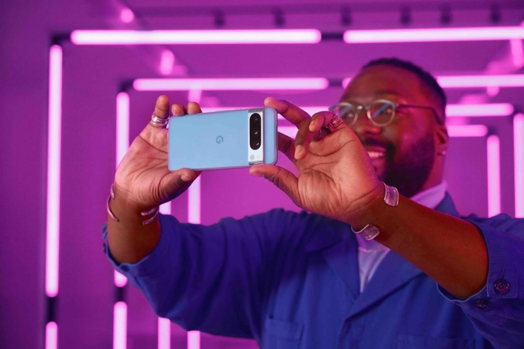Man holding Pixel 8 Pro, taking pics