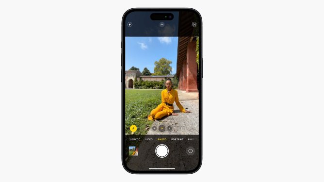 Apple iPhone 15 camera app demonstrating recognition of a person in the frame, a young Black woman in yellow