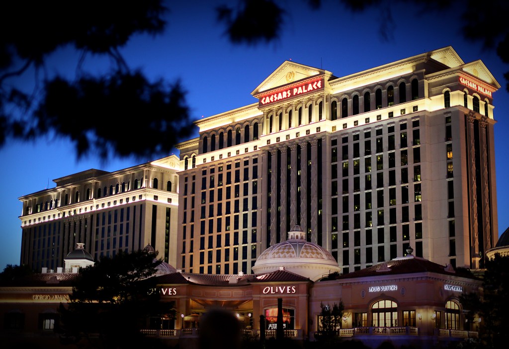 a photo of Caesars Palace Hotel sitting along Las Vegas Blvd, along the strip in Las Vegas, NV at night with the darkened sky