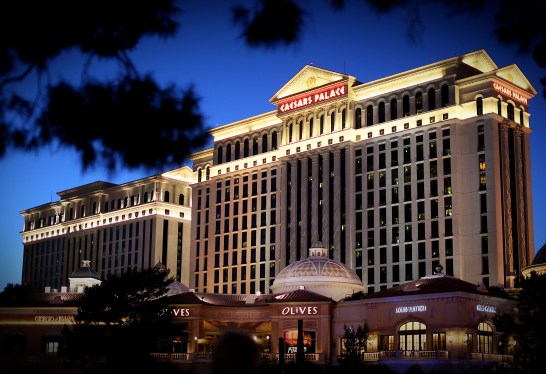 a photo of Caesars Palace Hotel sitting along Las Vegas Blvd, along the strip in Las Vegas, NV at night with the darkened sky