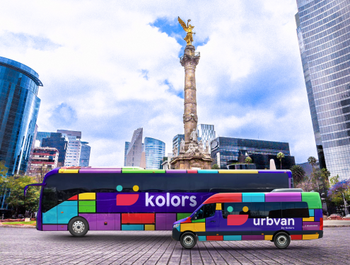Kolors bus and Urbvan van parked in a Mexican city.