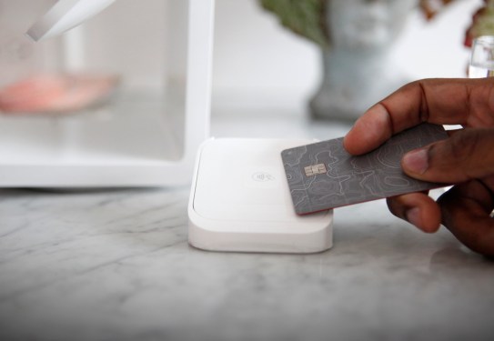Customer using contactless payment at modern wine bar counter, close-up
