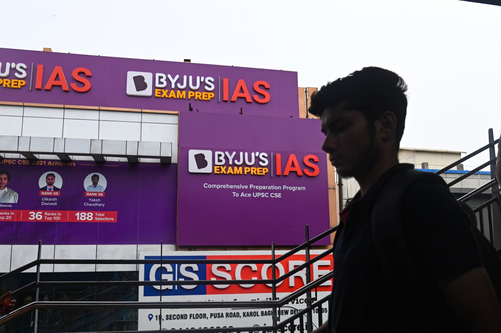 A boy walks past an hoarding of Byju's IAS coaching center in New Delhi, India on June 24, 2023. Byju's, an Education Technology company, and one of the top India's Startup, is in crisis since it has missed its interest payment on its $1.2 billion loan and other various issues. (Photo by Kabir Jhangiani/NurPhoto via Getty Images)