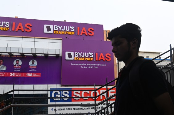 A boy walks past an hoarding of Byju's IAS coaching center in New Delhi, India on June 24, 2023. Byju's, an Education Technology company, and one of the top India's Startup, is in crisis since it has missed its interest payment on its $1.2 billion loan and other various issues. (Photo by Kabir Jhangiani/NurPhoto via Getty Images)