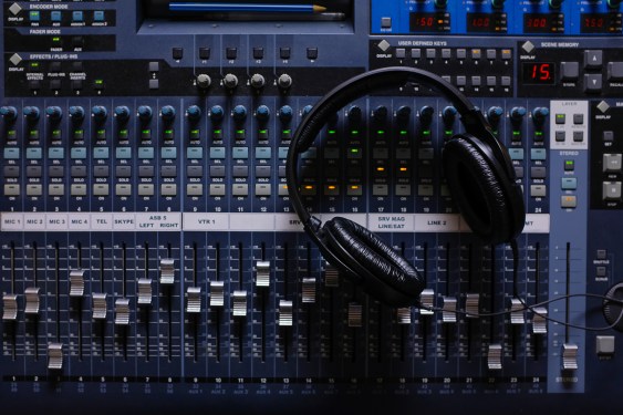 Headphones, Amplifying Equipment, Studio Audio Mixer Knobs, And Faders.