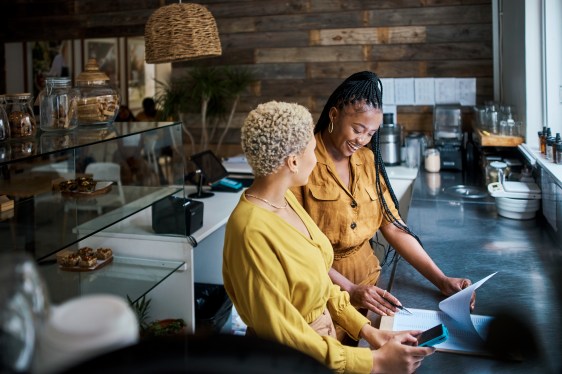 Small business owners talking and discussing the performance of their coffee shop