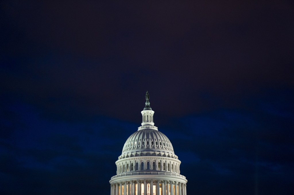 The U.S. Capitol building illuminated against a dark sky in Washington, D.C.,