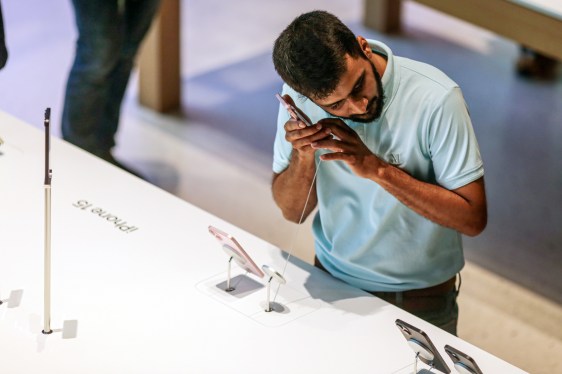 man checking out retail cell phone display