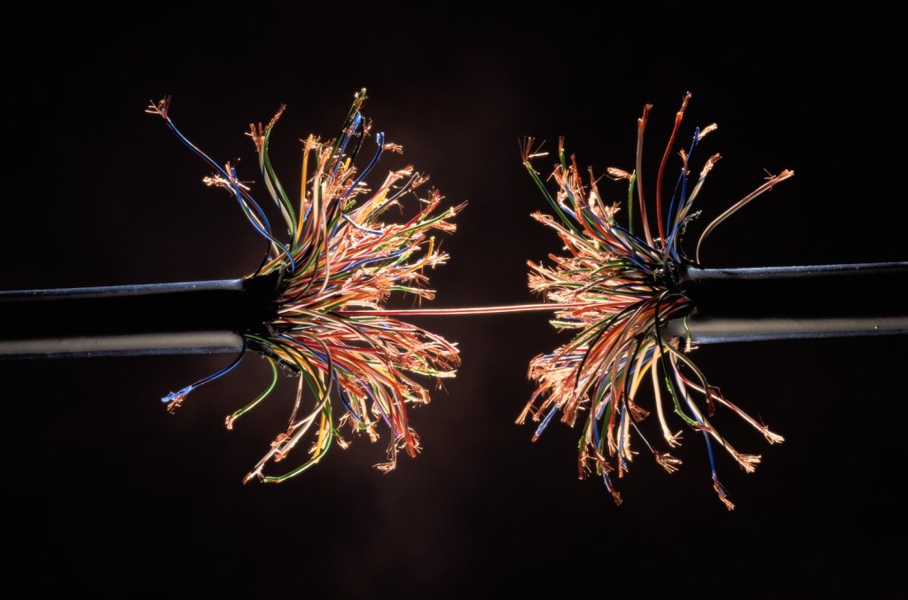 Single wire holding together frayed ends of model wiring harness