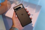 Google Pixel 8 Pro in Obsidian, with the back facing the camera, held in a hand