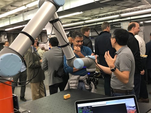 A robot arm among people at MassRobotics