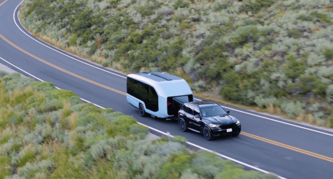 A BMW SUV towing a white, modern-looking Pebble electric travel trailer