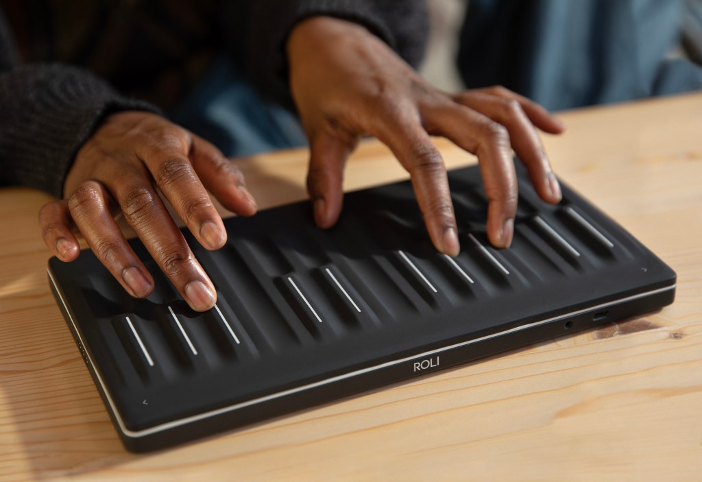 two hands playing a Roli Seaboard