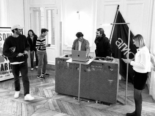 Amo team members in their office while one of them is DJing