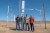 AirLoom team stand in front of a demo of their wind power installation.
