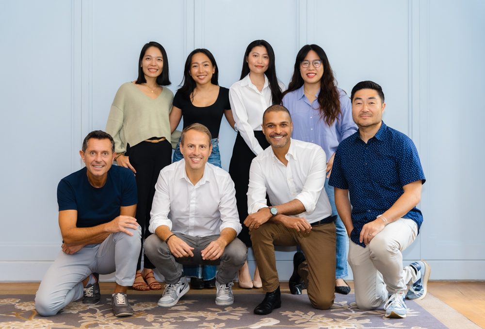 FEBE Ventures' team standing against a blue wall