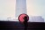 Women with red umbrella in front of city skyline